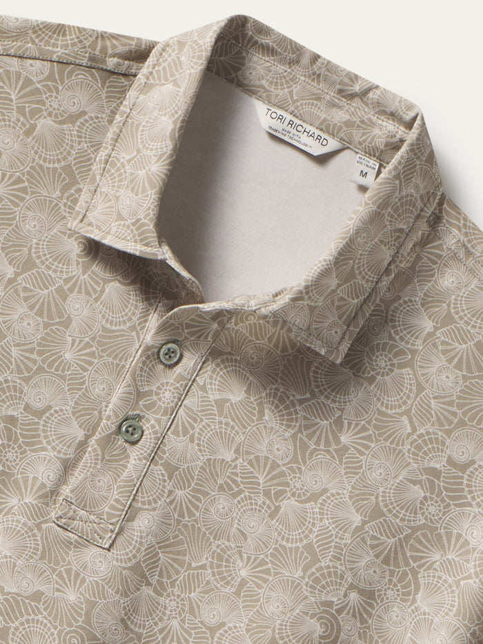 Beige geometric seashell-print Pima cotton polo shirt, front view with visible tag shown in both images.