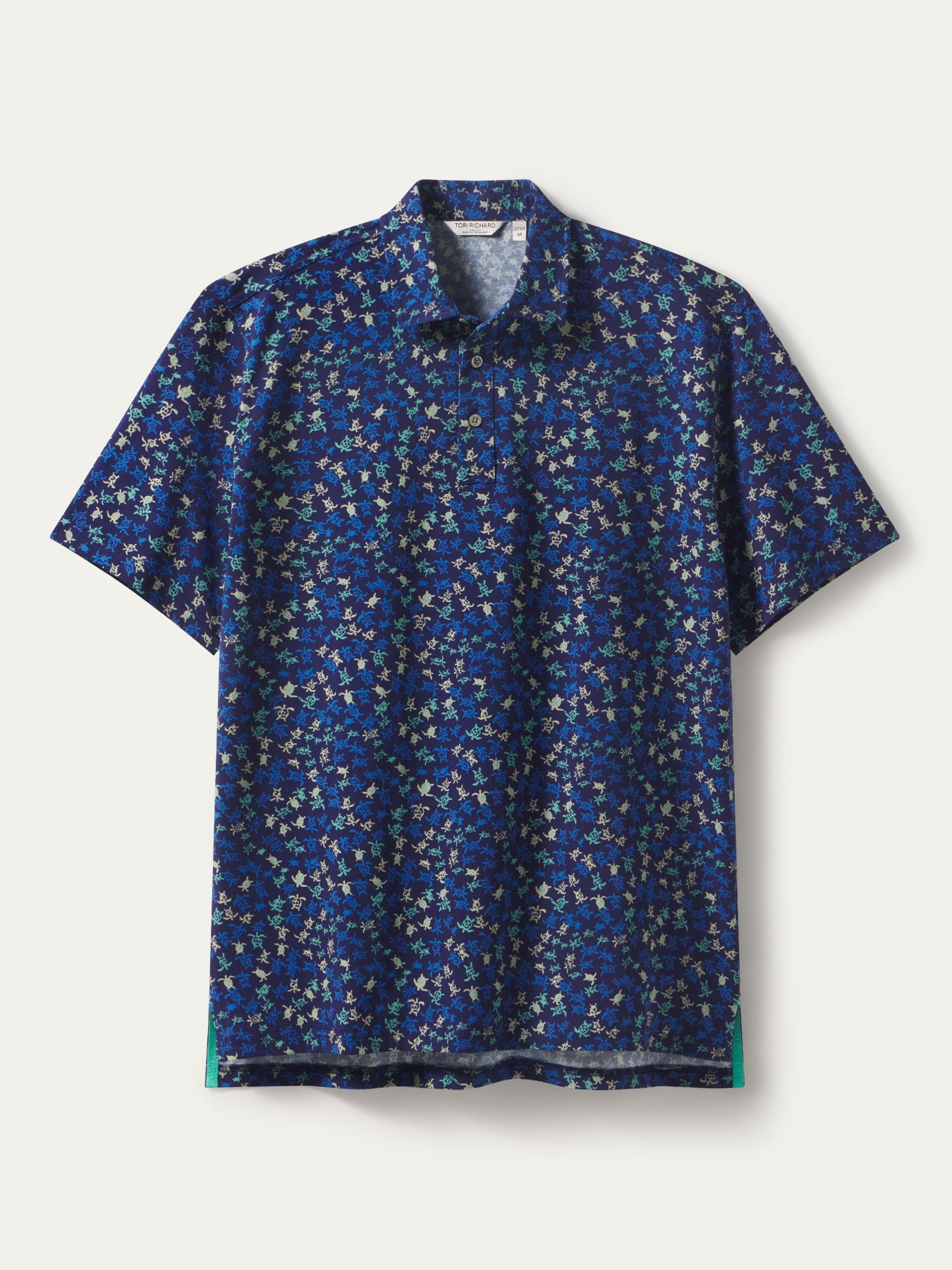 White short-sleeve polo with colorful floral print in blue Pima cotton, front view.