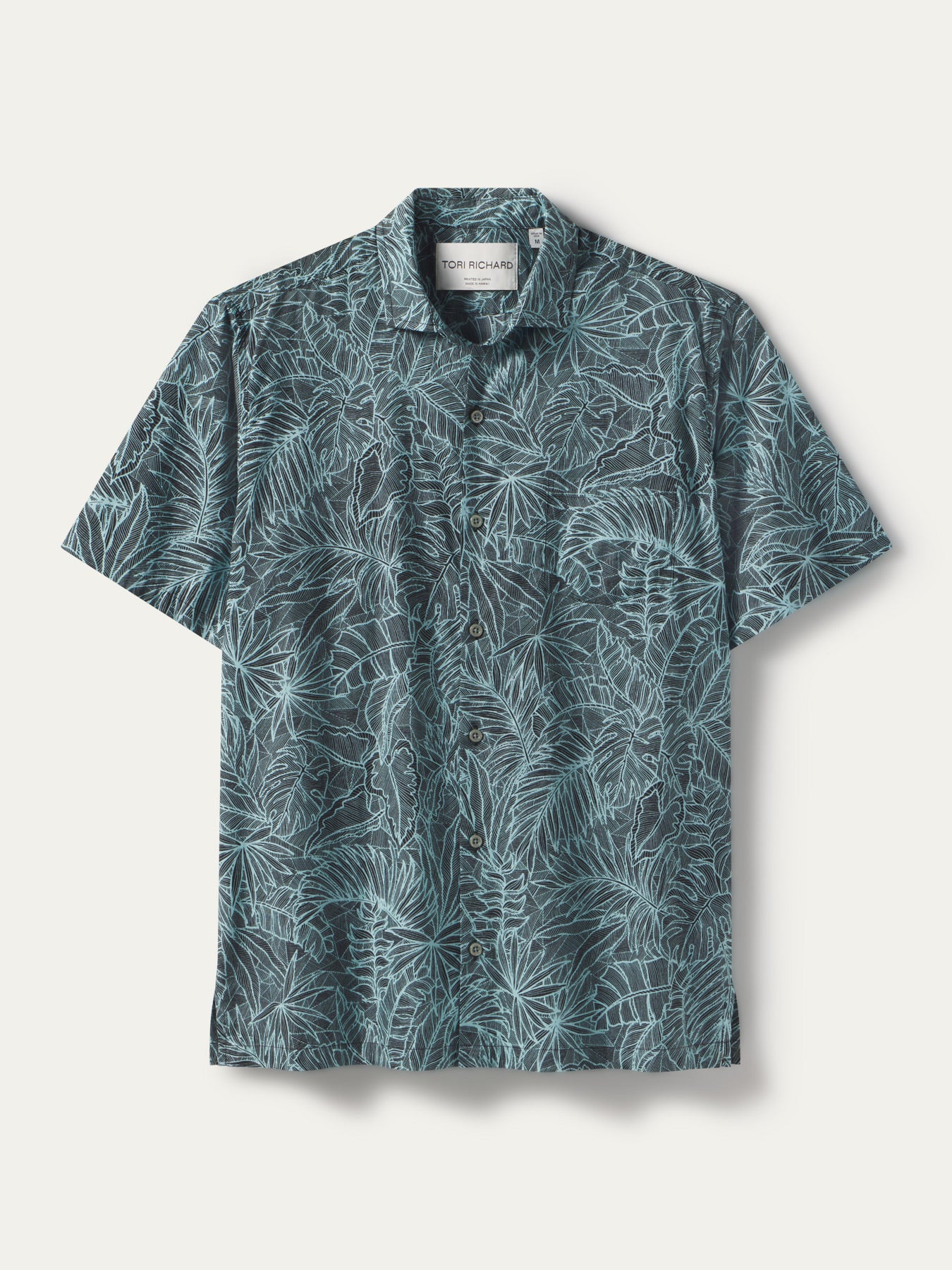 Blue tropical leaf-print short-sleeve button-up shirt, flat lay view shown in both images.