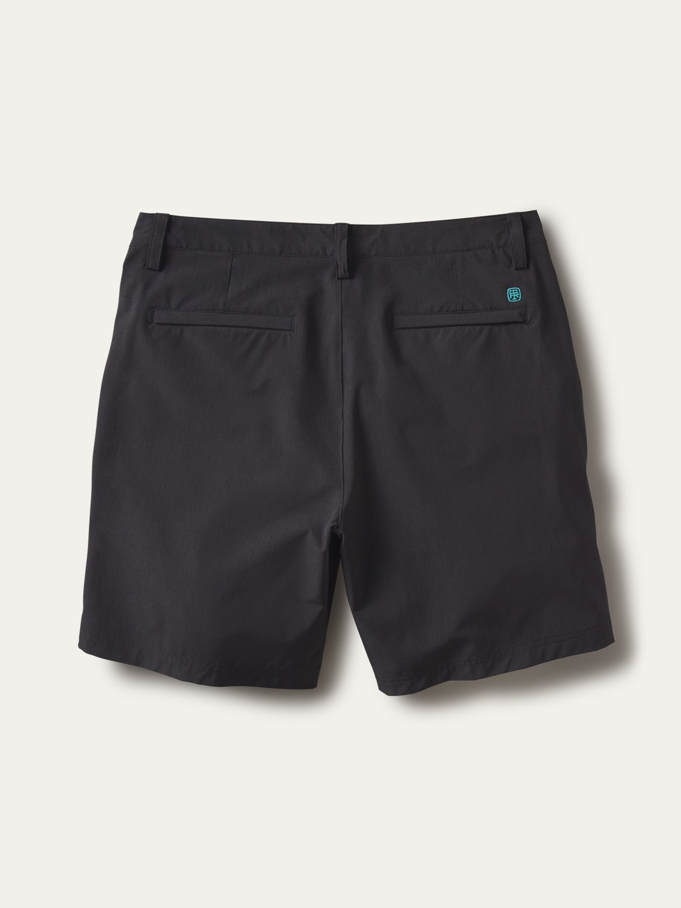 Blue solid-performance shorts, back view with belt loops, two back pockets, and logo above pocket.