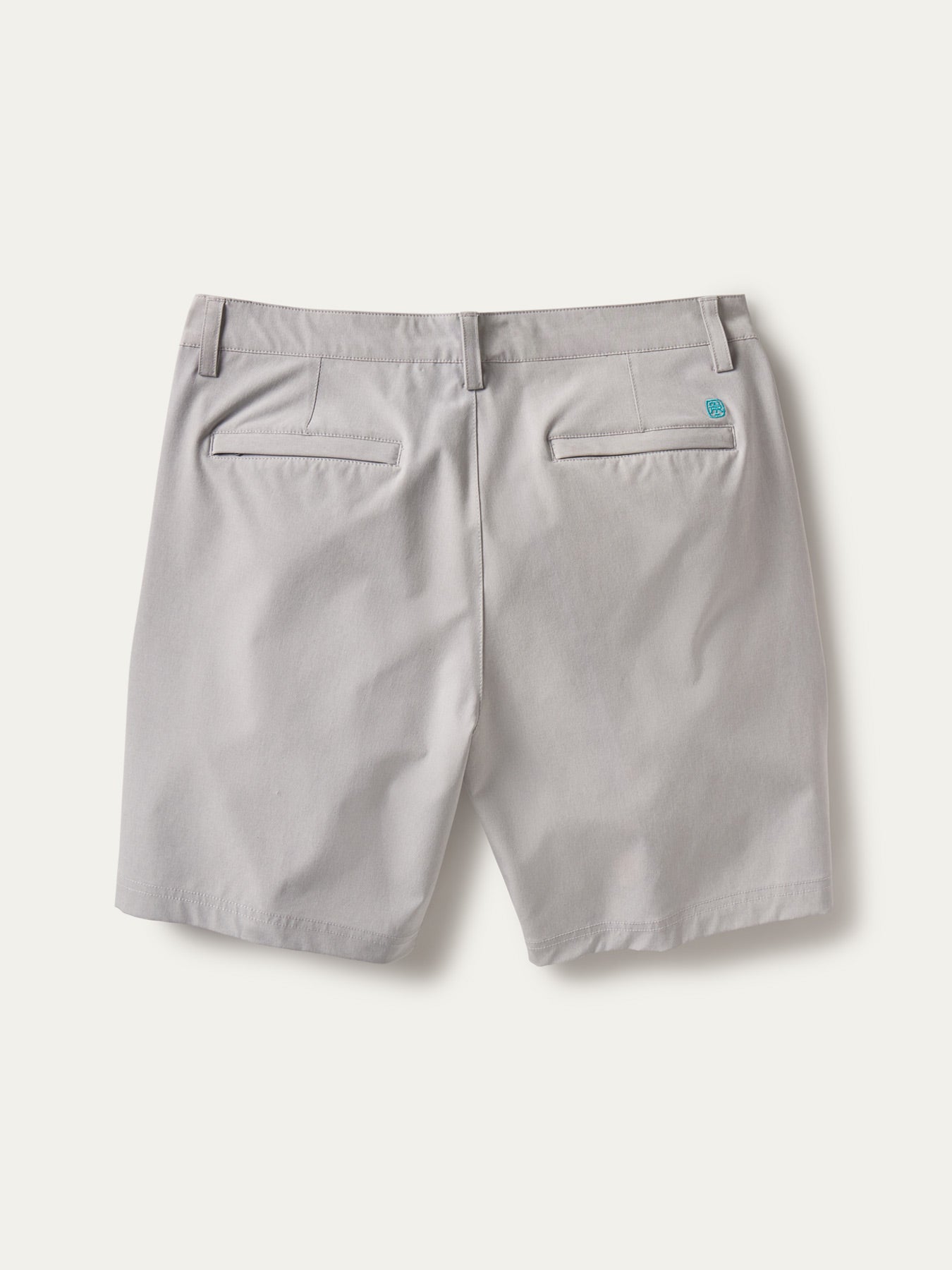 Light gray solid performance shorts with welt pockets and belt loops, back view shown in two images.