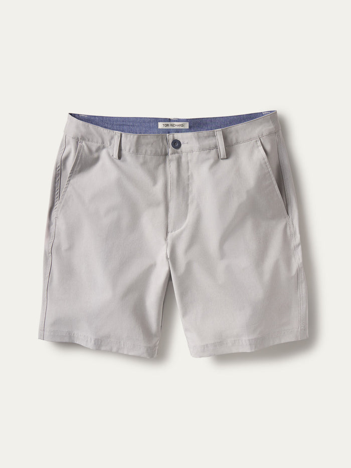 Light gray solid performance shorts, four-way stretch, side pockets, belt loops; front and back views.
