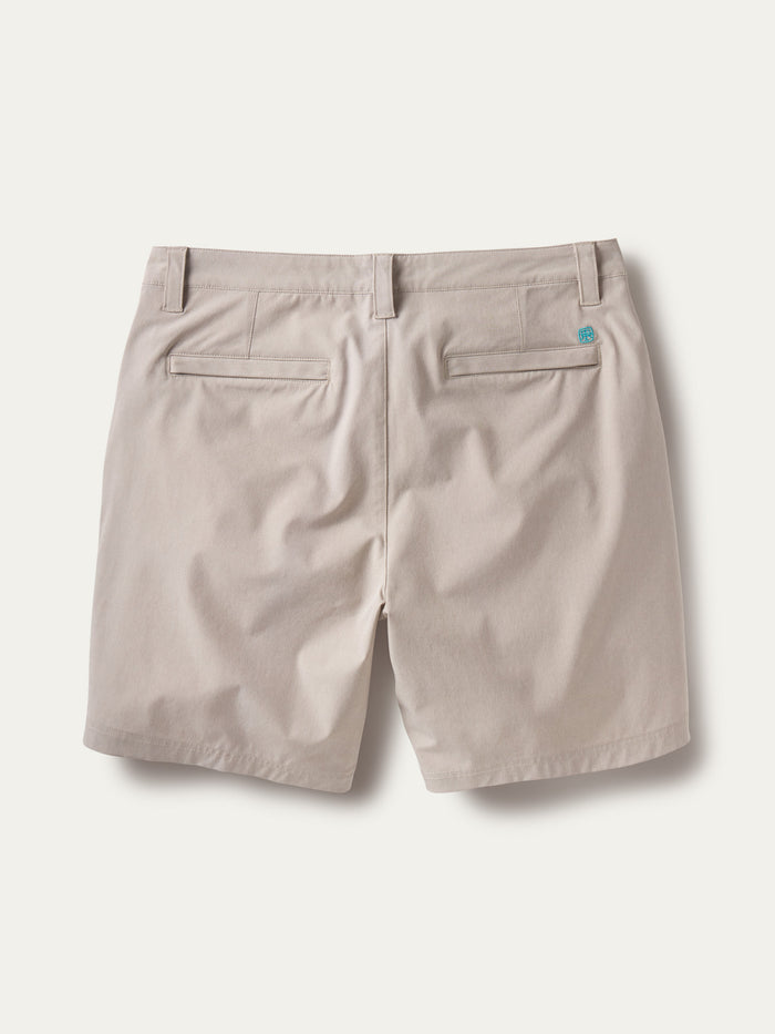 Beige performance shorts, back view; belt loops, welt pockets, stretchy fabric.