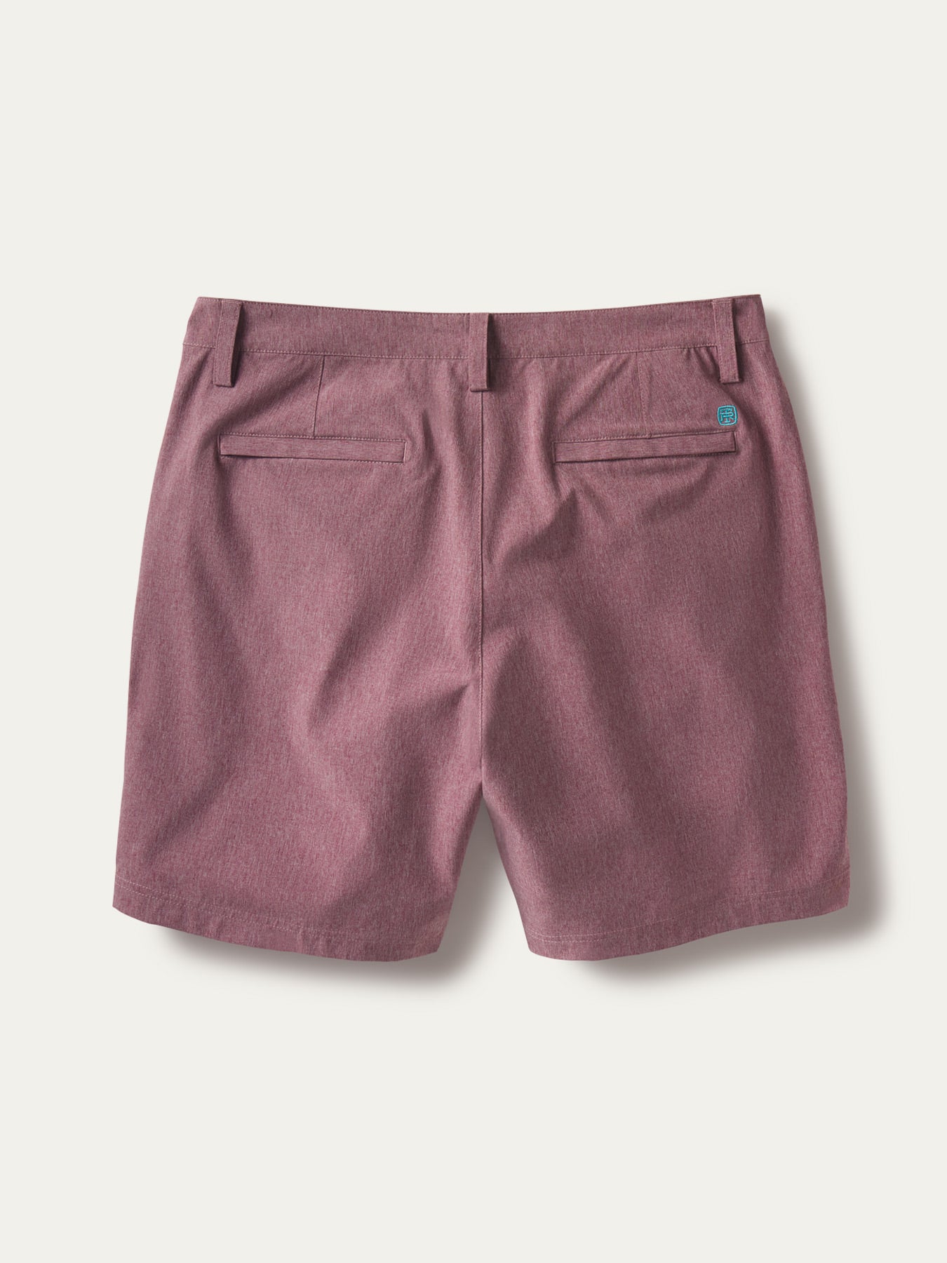 Mauve solid performance shorts, back view with welt pockets and belt loops on white{{/AltText}}.