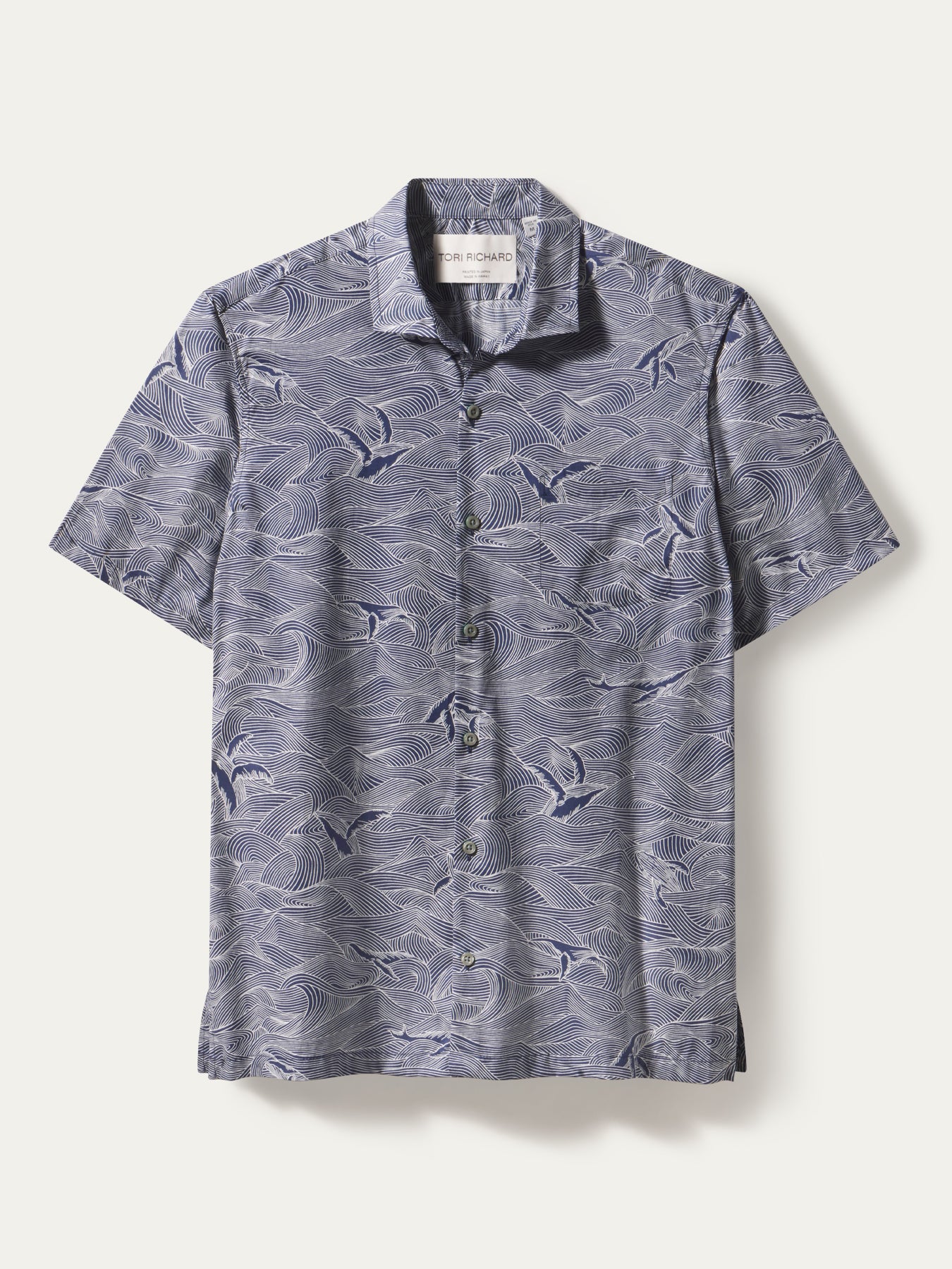 Blue and white wave-print Whale Season short-sleeve button-down shirt, front view.{{/AltText}}.