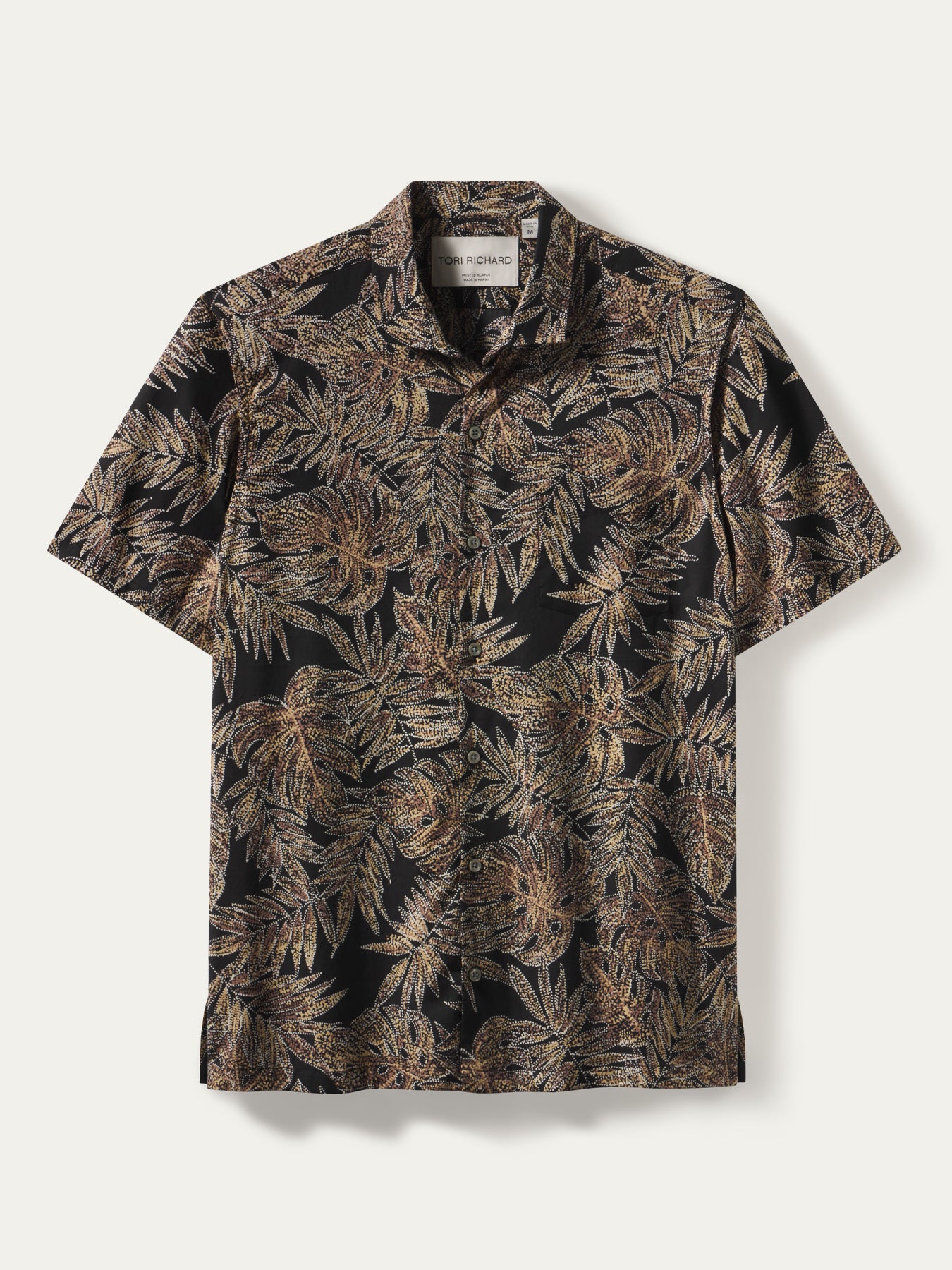 Black and gold-brown tropical leaf print short-sleeve shirt, front and back views.