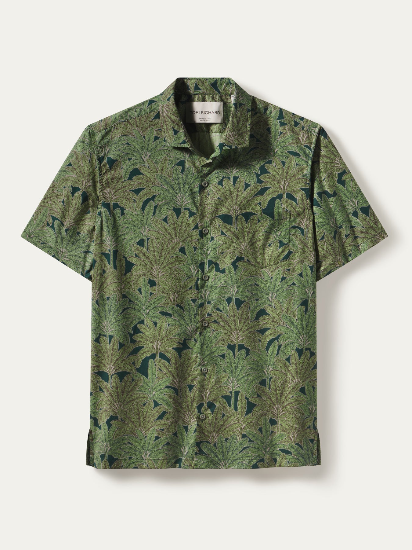 Dark cotton short-sleeve shirt with green banana grove print, flat lay view shown in both images.