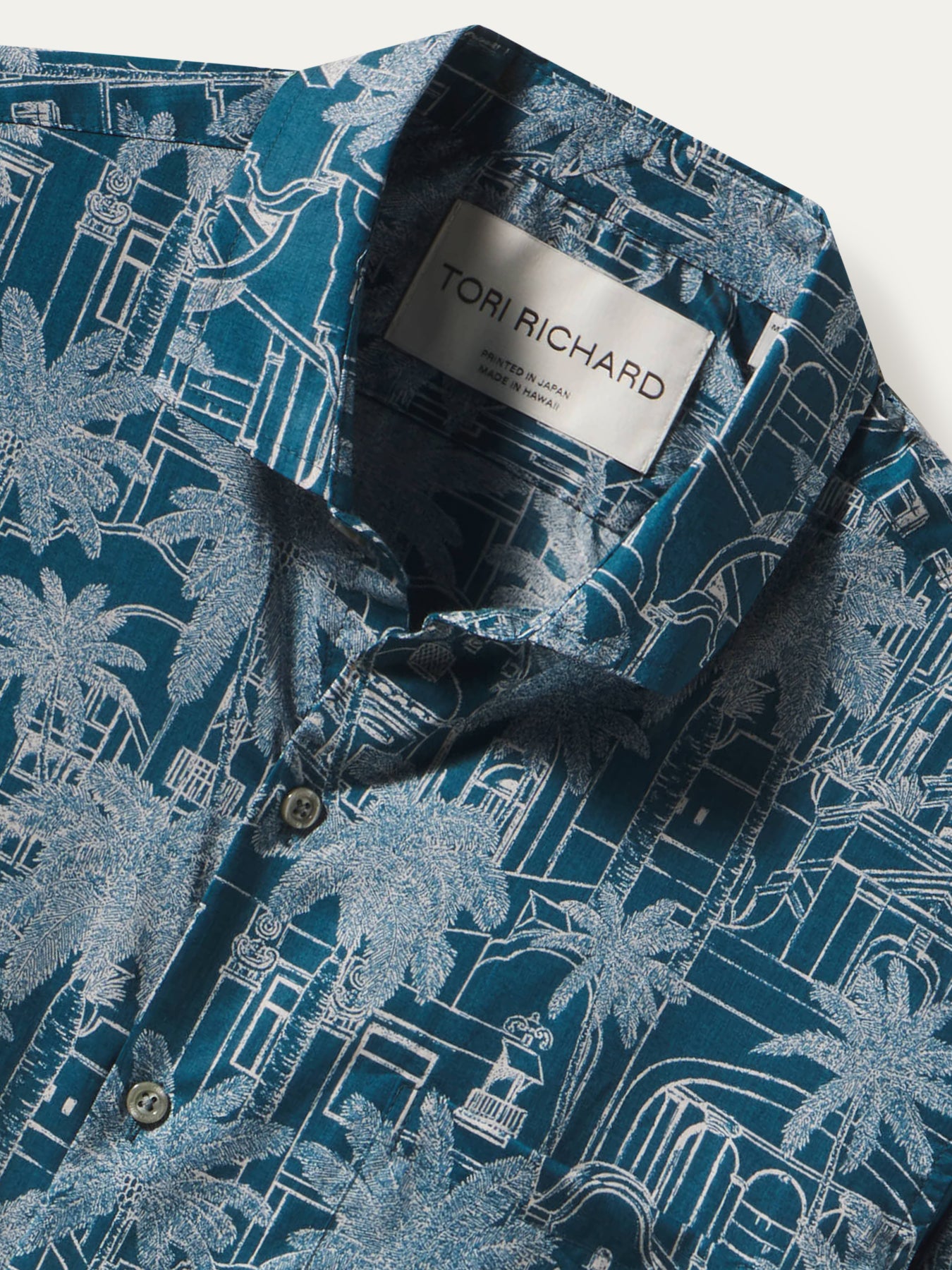 Blue and white palm-and-building print cotton short-sleeve shirt, front view shown in Images 1 and 2.