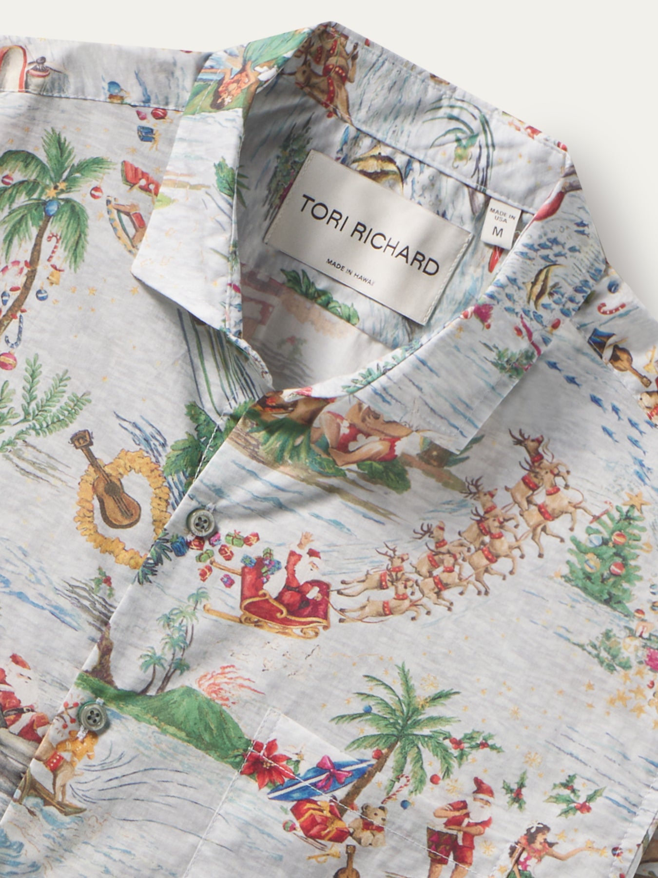 White cotton shirt with Santa, reindeer, palm tree print; close-up of label shown in both images.