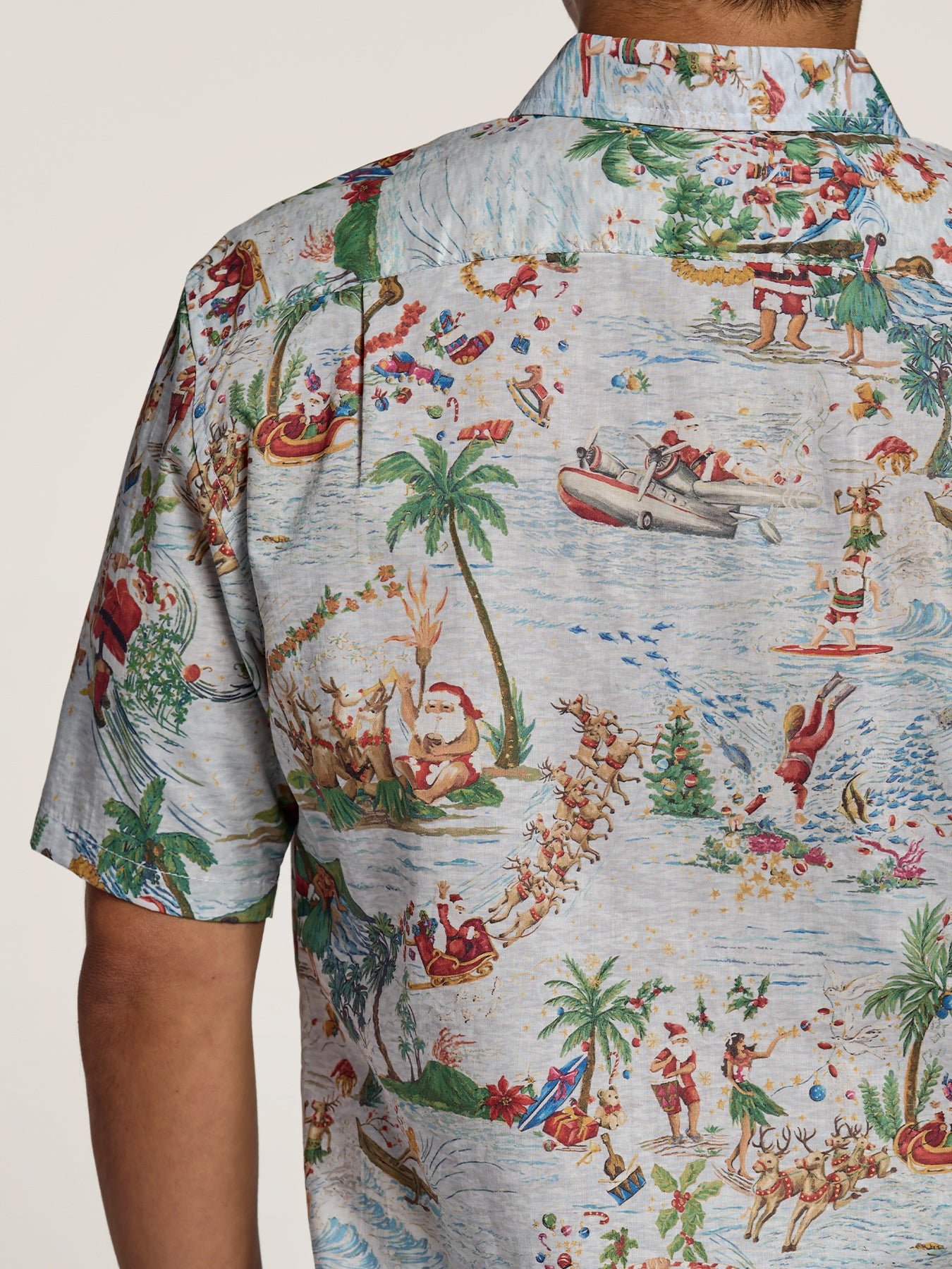 Light blue shirt with cartoon Santa and reindeer print, front view.