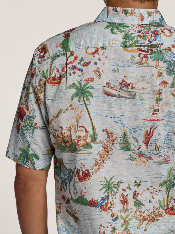 Light blue shirt with cartoon Santa and reindeer print, front view.