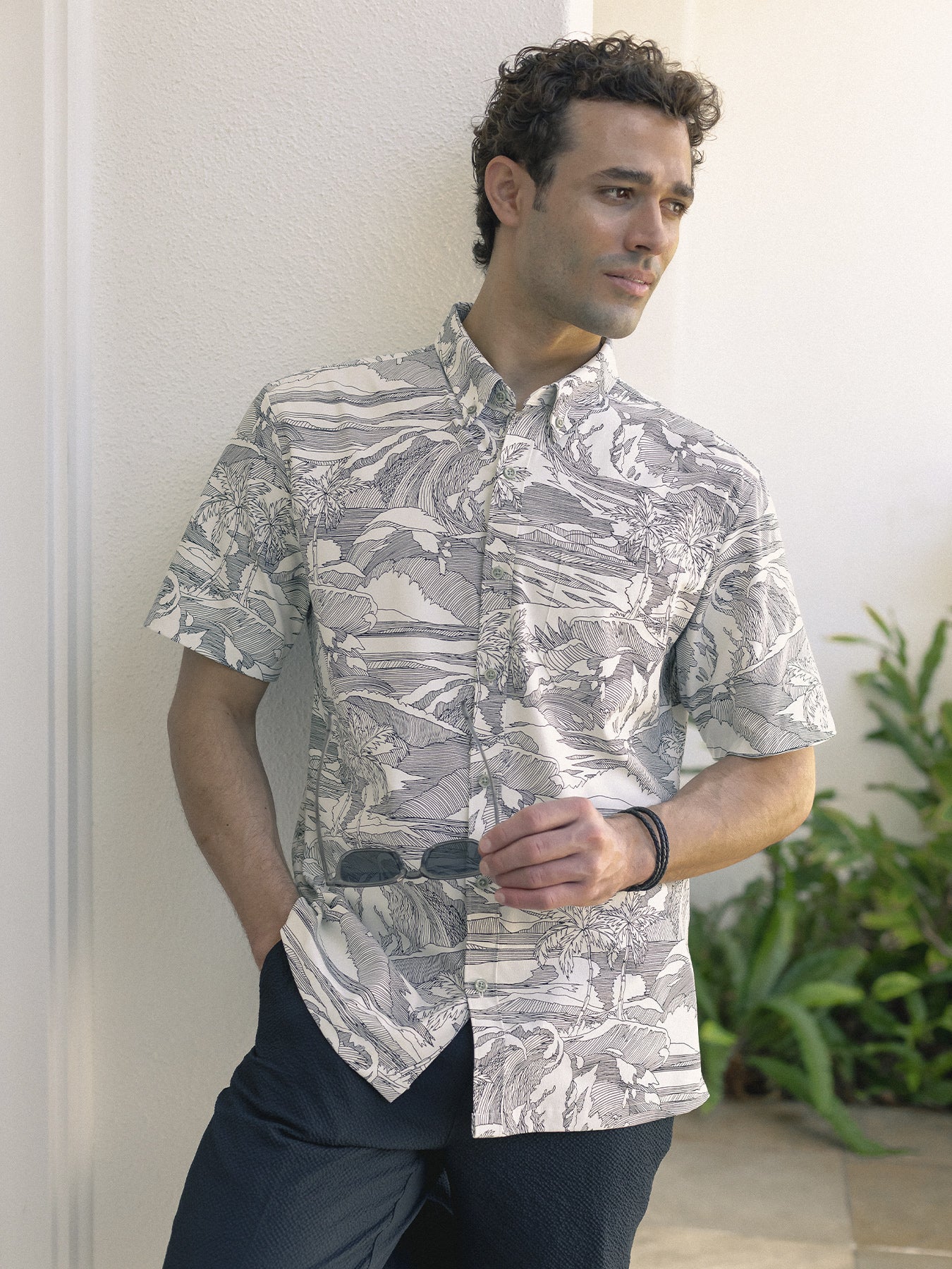 Gray and white nature-print short-sleeve shirt with UPF, front view, with dark pants.