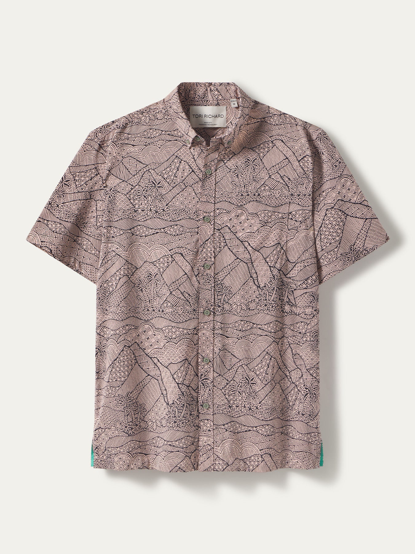 Light brown short-sleeve shirt with black mountain forest tapa pattern, front view; tapa-print shirt, front view.