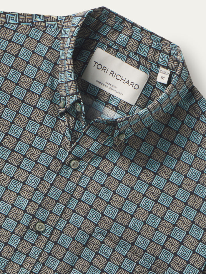 Blue geometric-print button-up shirt, mid-century Waikiki-inspired, front view.