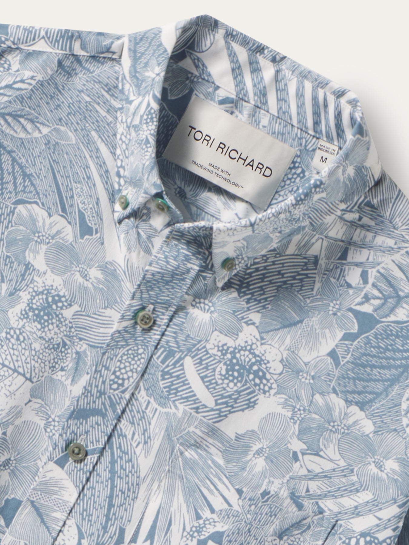 Blue and white floral button-down shirt with greenish buttons, front view shown in both images.