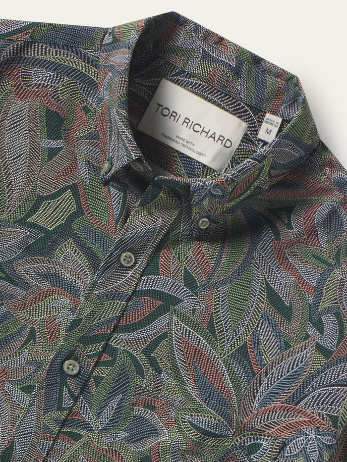 Multicolored leaf-print, moisture-wicking button-up shirt, front view shown in both images.
