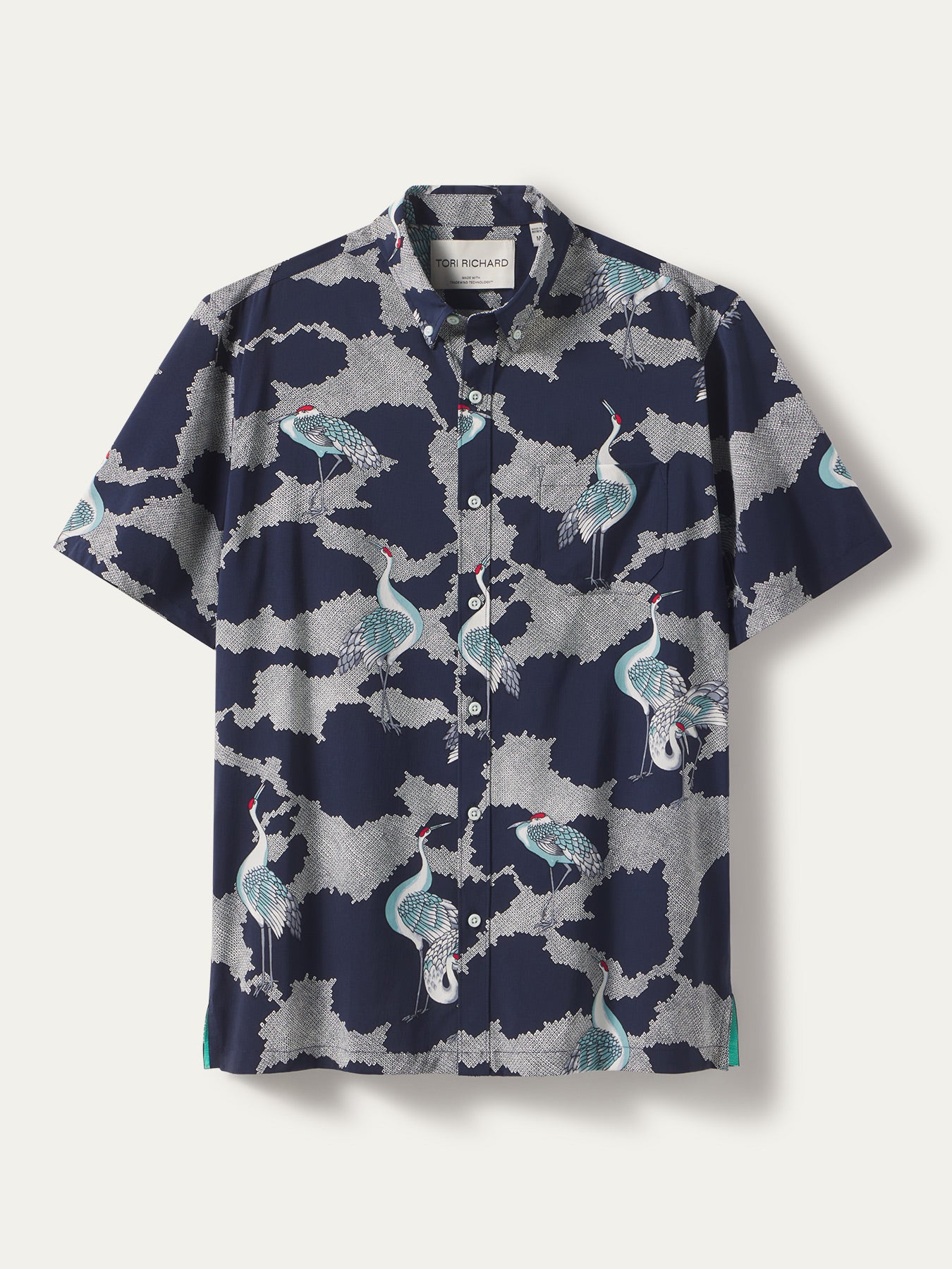 Navy shirt with white, blue, and teal crane and cloud print, vintage-style; front view.