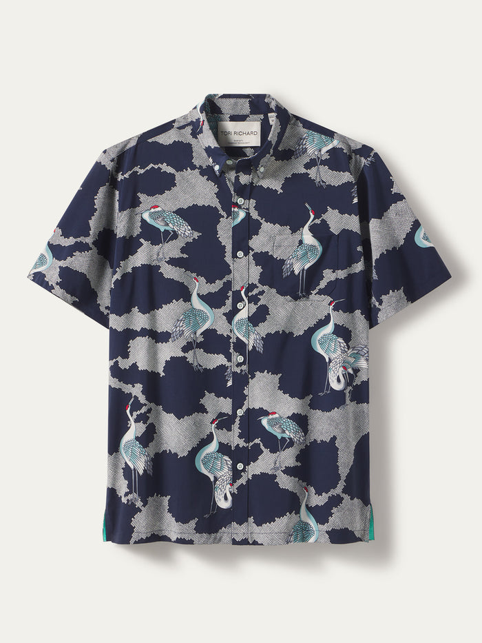 Navy shirt with white, blue, and teal crane and cloud print, vintage-style; front view.