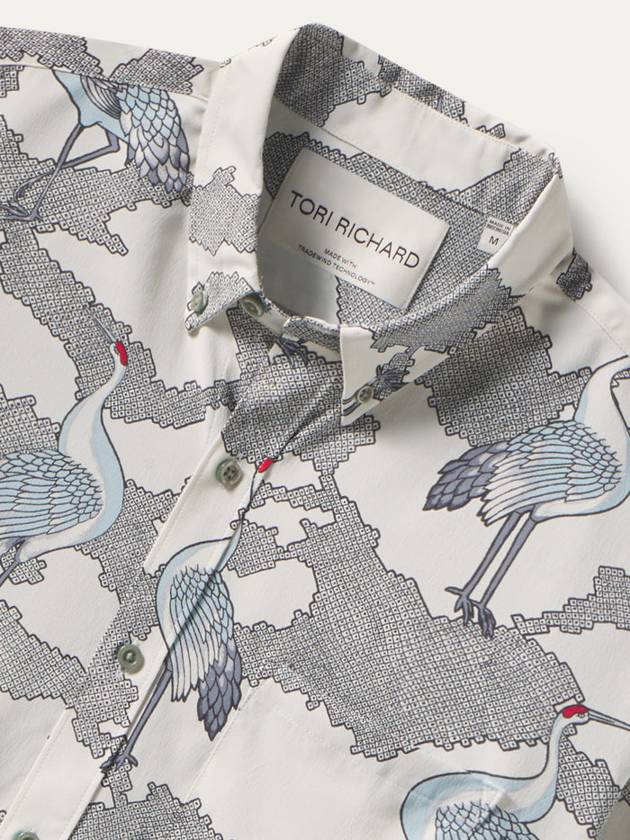 Image 1: White shirt, blue crane & geometric pattern, long sleeves. Image 2: Same shirt, front detail shown.