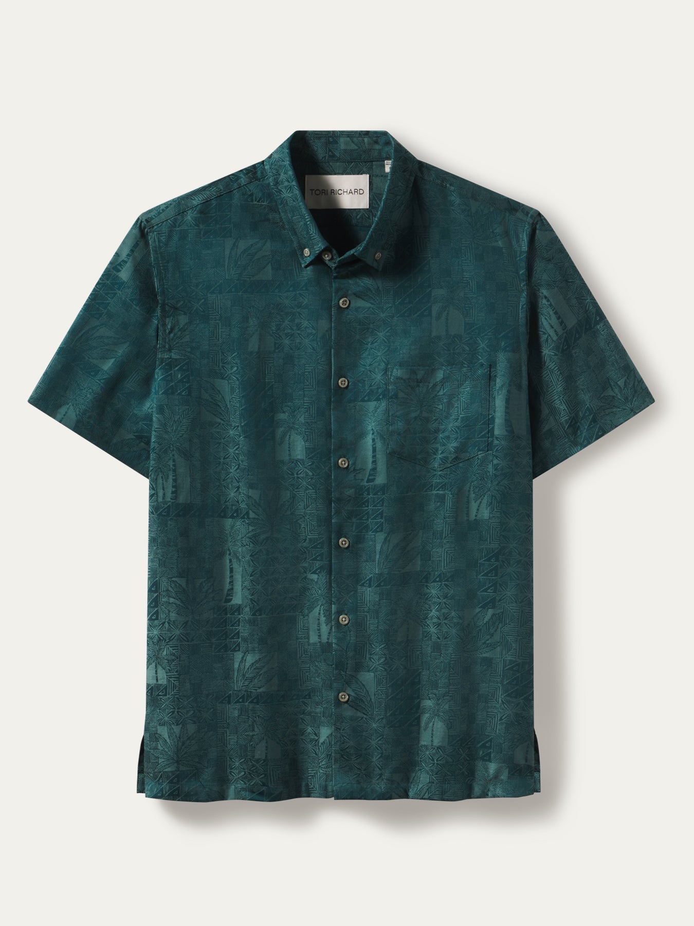 A short-sleeve button-up shirt in a dark teal green color with a subtle tonal graphic pattern, displayed flat against a light off-white background.