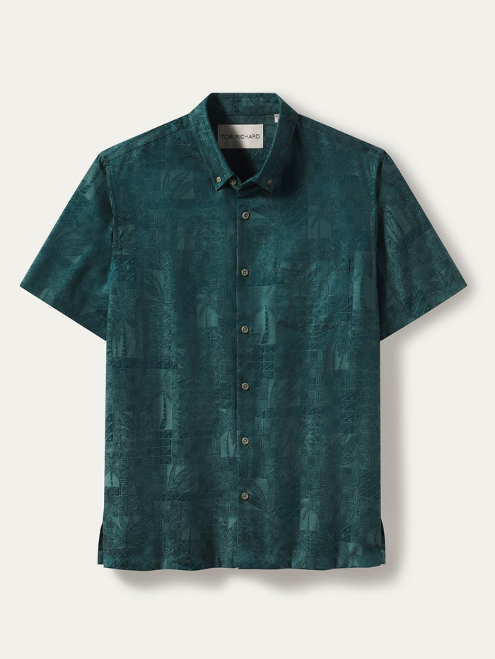 A short-sleeve button-up shirt in a dark teal green color with a subtle tonal graphic pattern, displayed flat against a light off-white background.