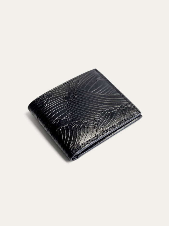 A black leather bifold wallet with an embossed wave pattern, shown on a light off-white background.