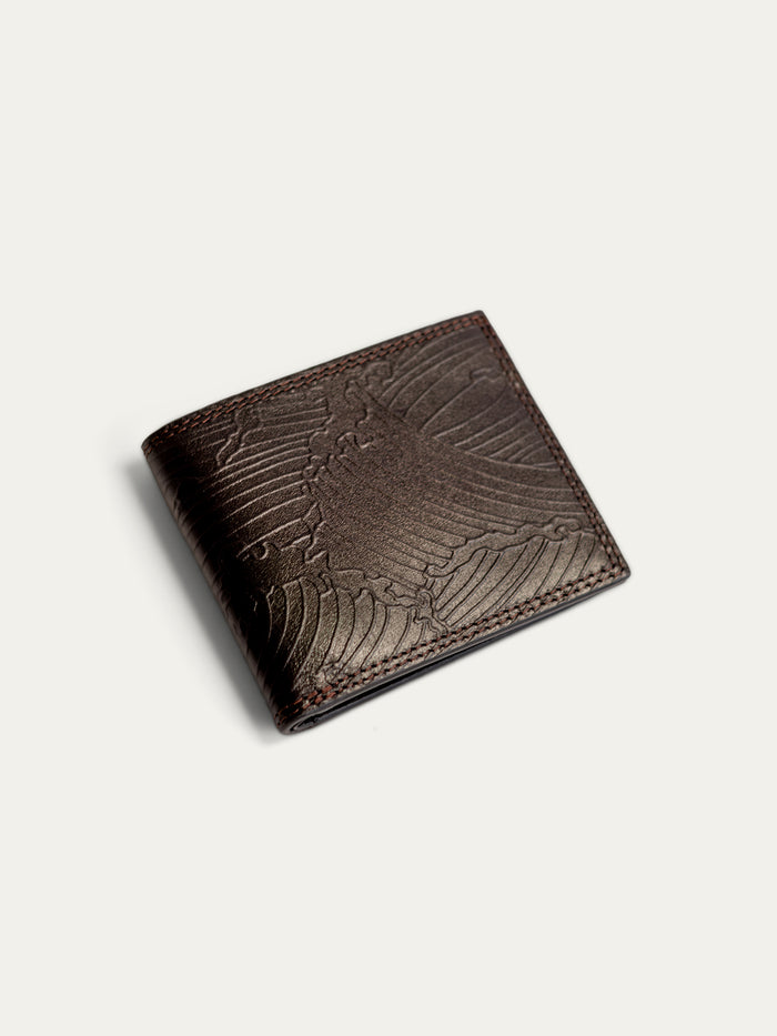 A dark brown leather bifold wallet with an embossed eagle design on the front, shown on a light off-white background.