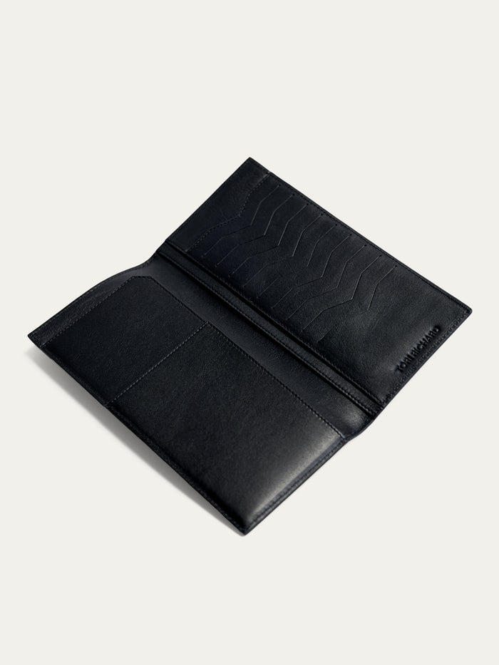 Black leather travel wallet with card slots and pocket, shown open on light background in two images.