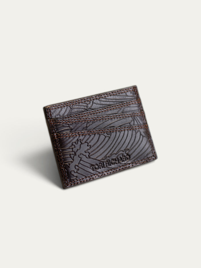 A dark brown leather card holder wallet.
