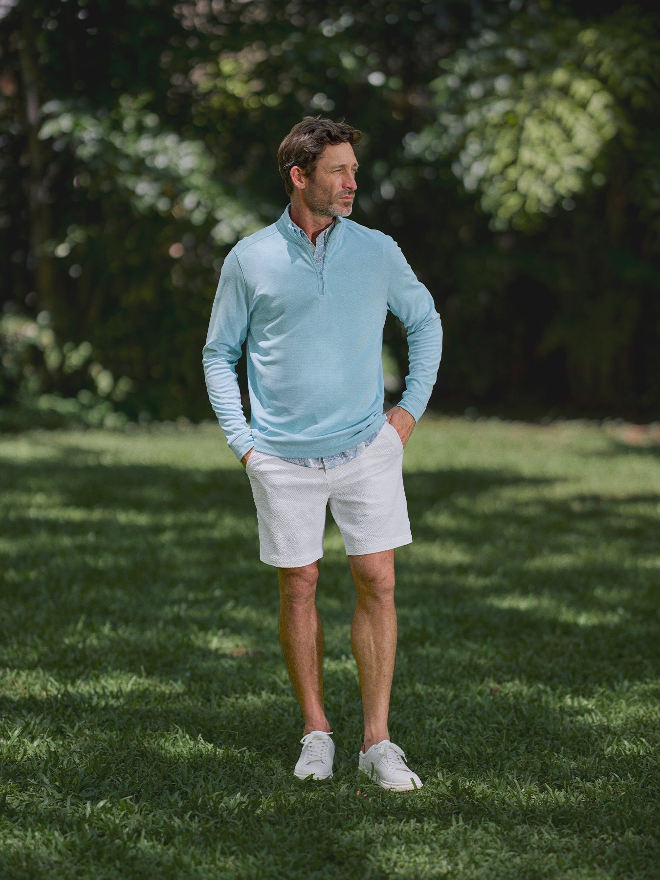 Light blue quarter-zip sweater and white The Lanai Short – Tradewind Technology®, full view.{{/AltText}}.