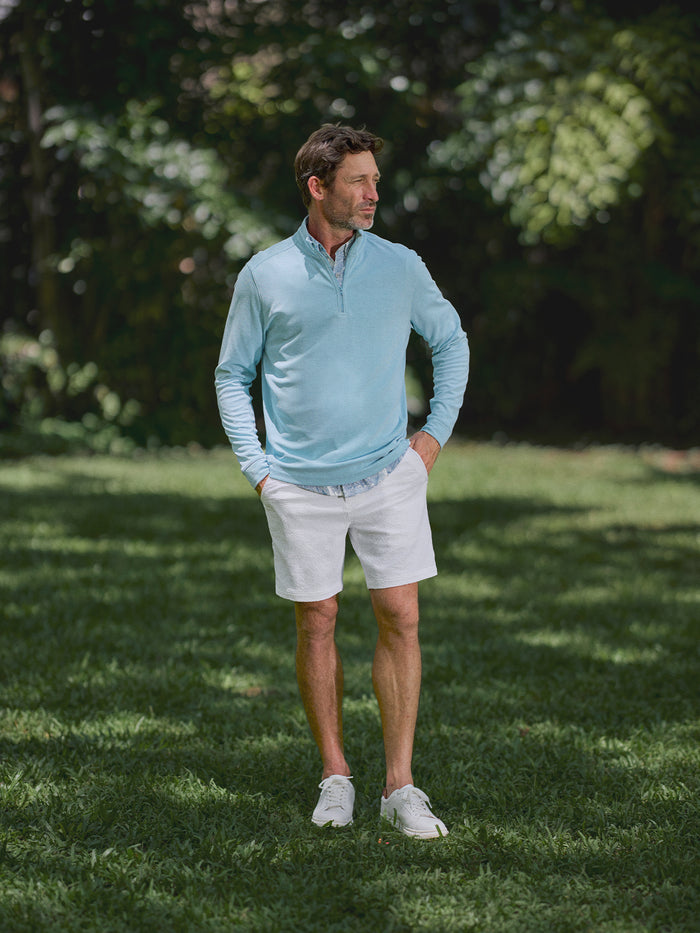 Light blue quarter-zip sweater and white The Lanai Short – Tradewind Technology®, full view.{{/AltText}}.