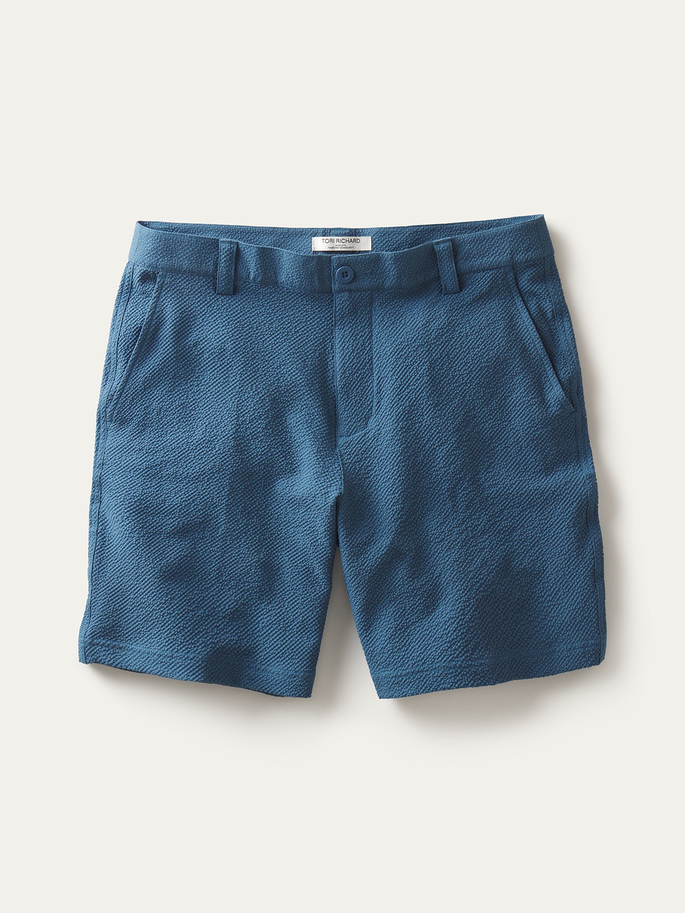 Blue solid shorts with belt loops and side pockets, shown from front and angled views.