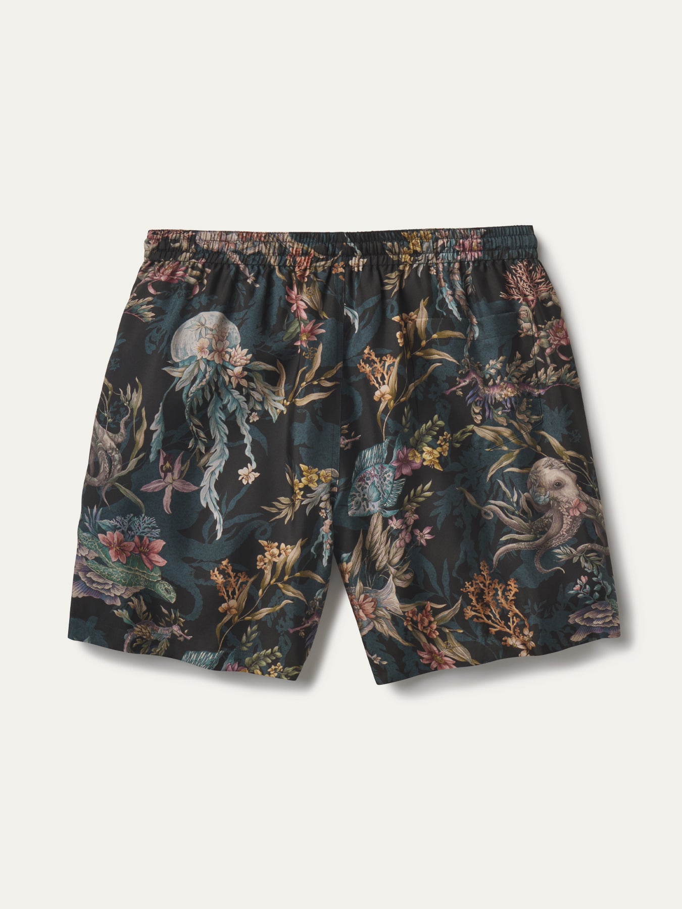 A pair of men's swim shorts featuring an intricate, dense underwater-themed print with jellyfish, sea plants, and sea creatures on a dark teal background, shown flat against a light off-white background.