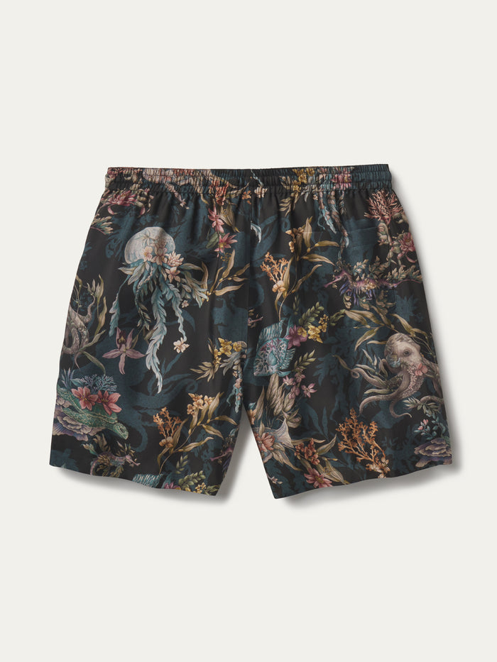A pair of men's swim shorts featuring an intricate, dense underwater-themed print with jellyfish, sea plants, and sea creatures on a dark teal background, shown flat against a light off-white background.
