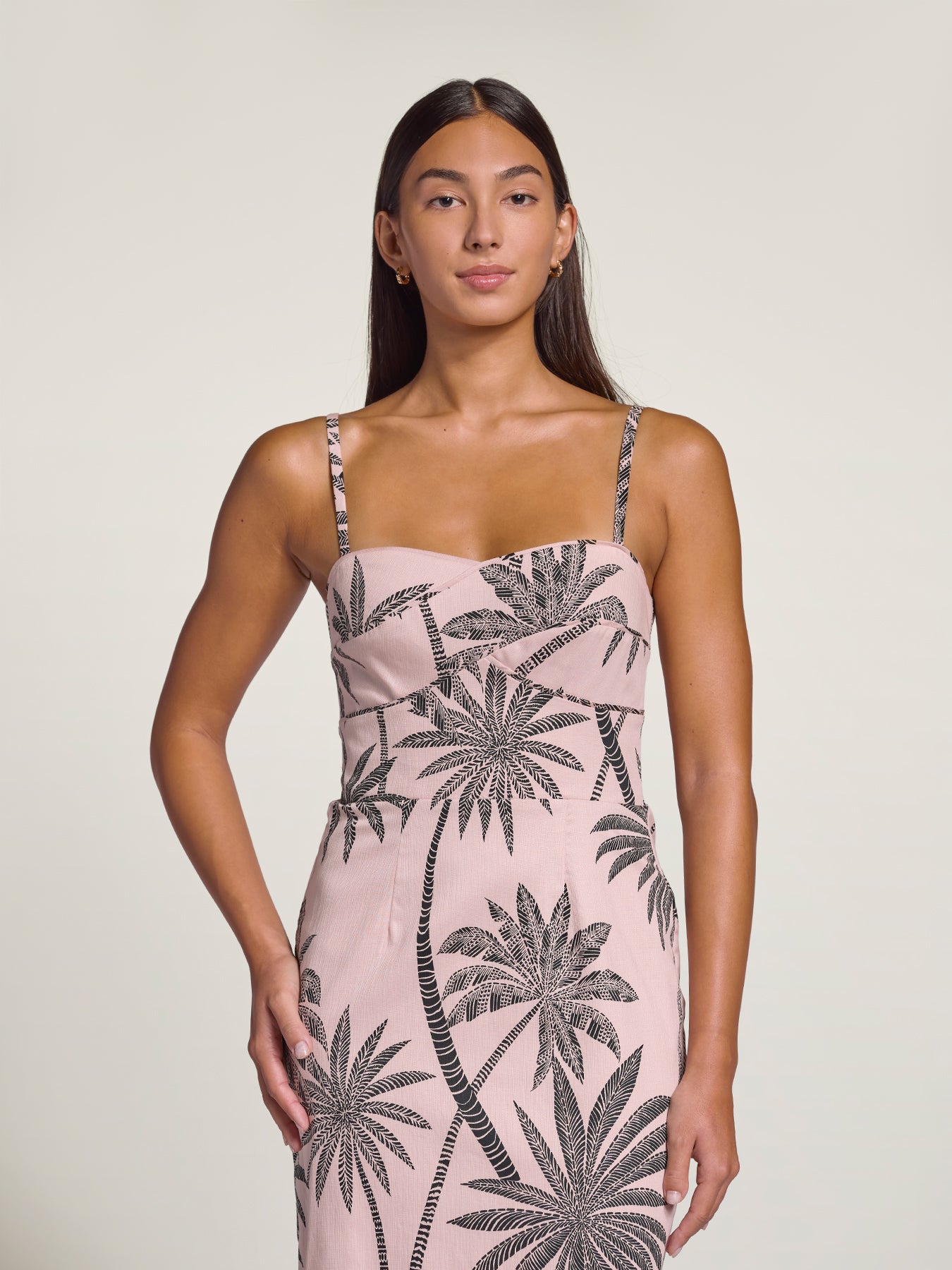 White sleeveless dress with black palm print, full-length front view shown in both images.