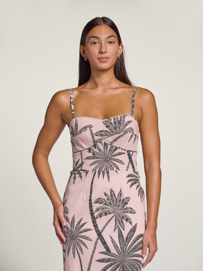 White sleeveless dress with black palm print, full-length front view shown in both images.
