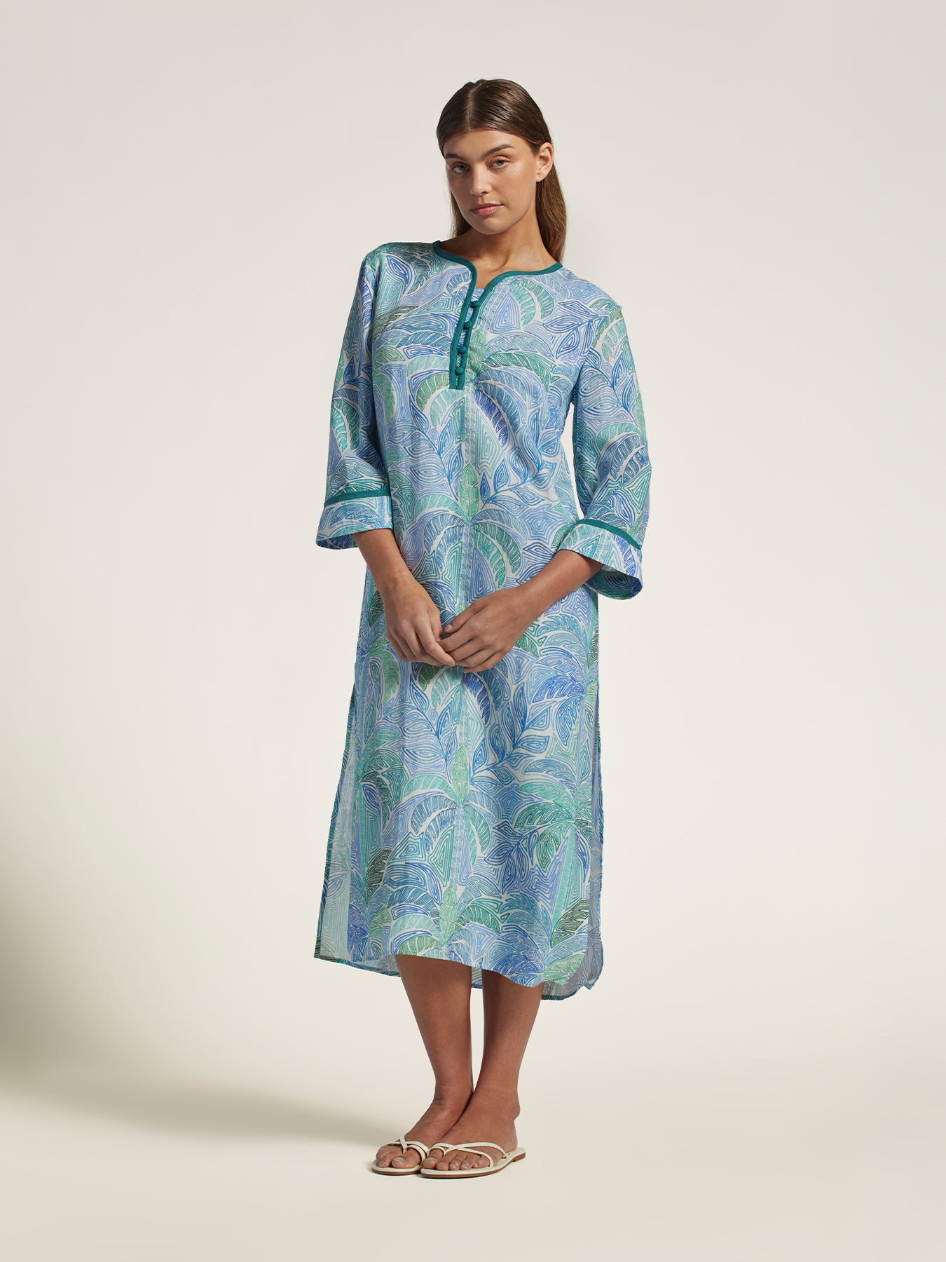 Blue-green abstract patterned linen midi caftan, barefoot, front view shown.