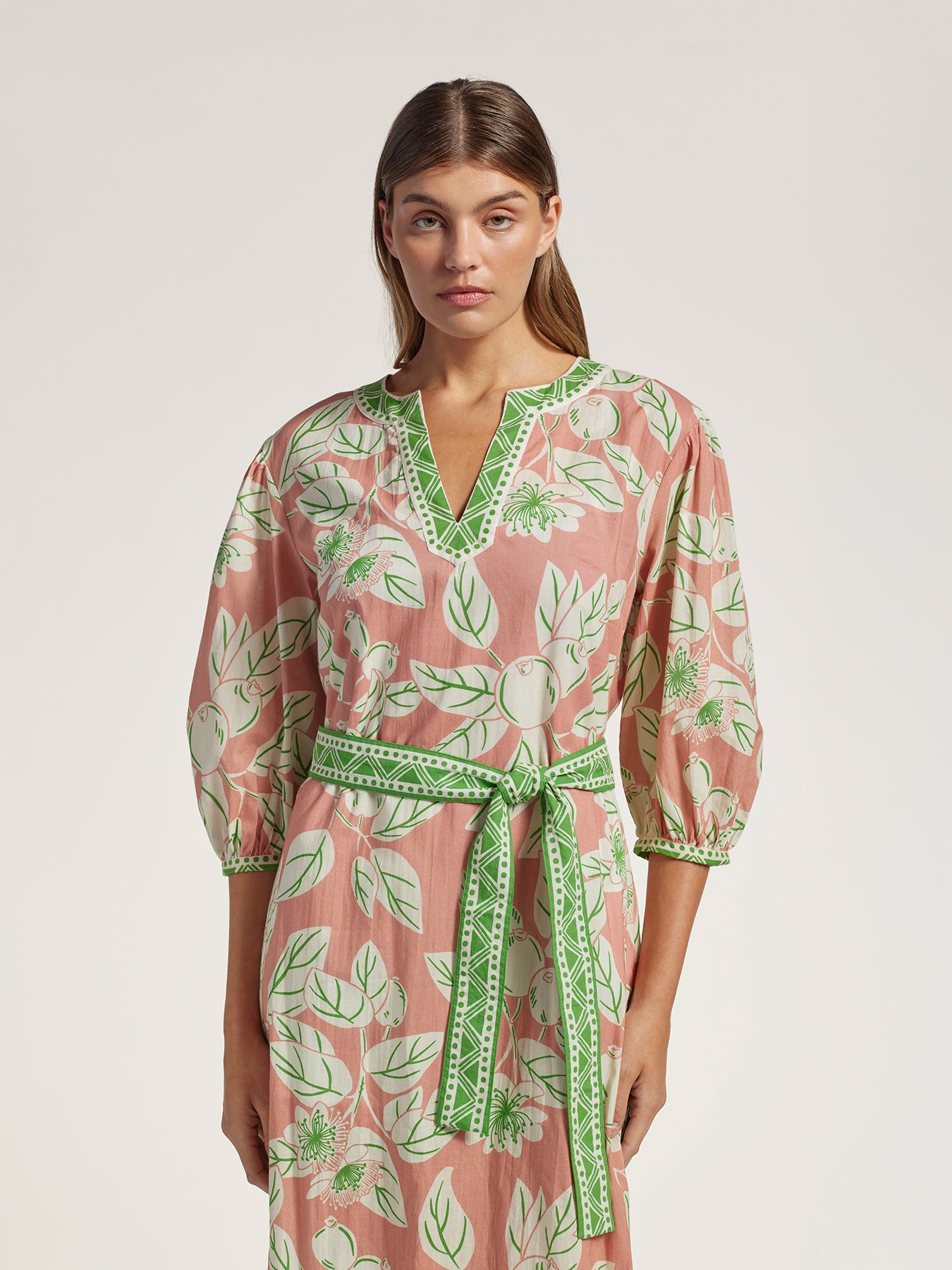 Pink and green guava print caftan, midi length, sash waist tie, front view.