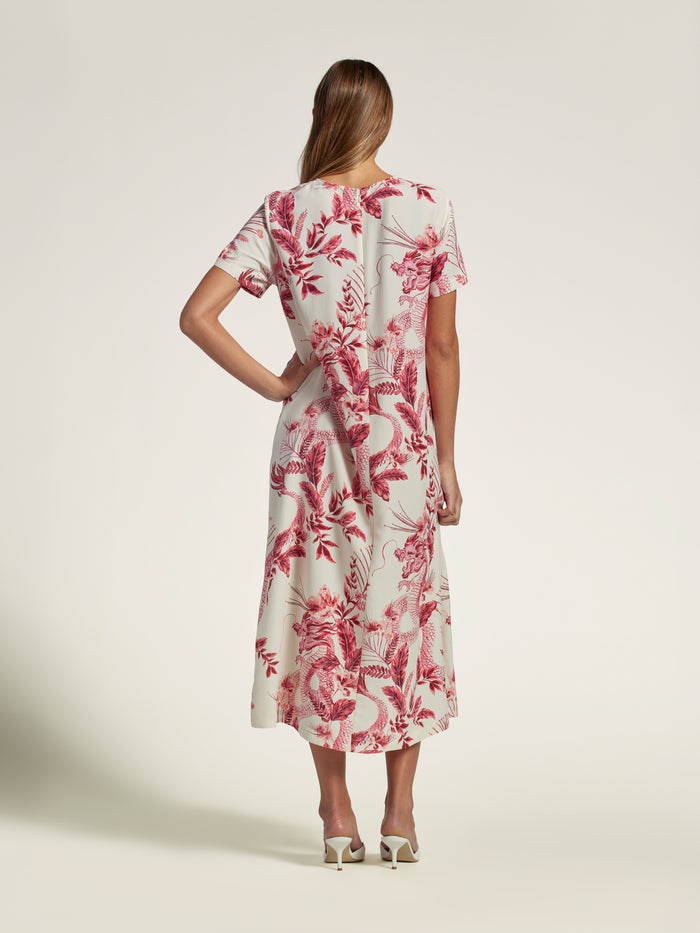 Deep green solid maxi dress, back view, white heel detail.
