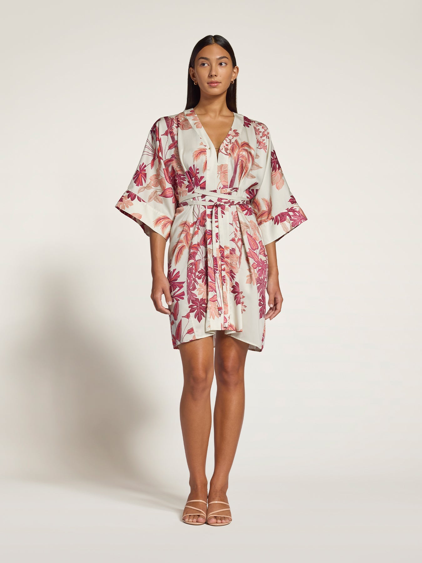 Yellow floral-print short wrap dress with belt, full-body front view, light backdrop .