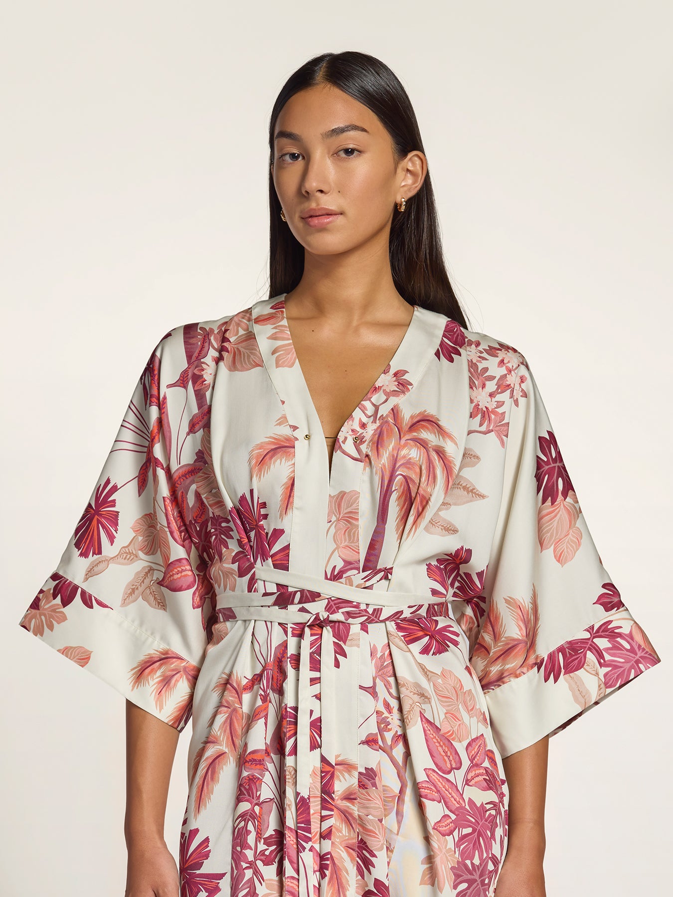 Pink and red floral-print kimono-style wrap dress, full front view on pale background.