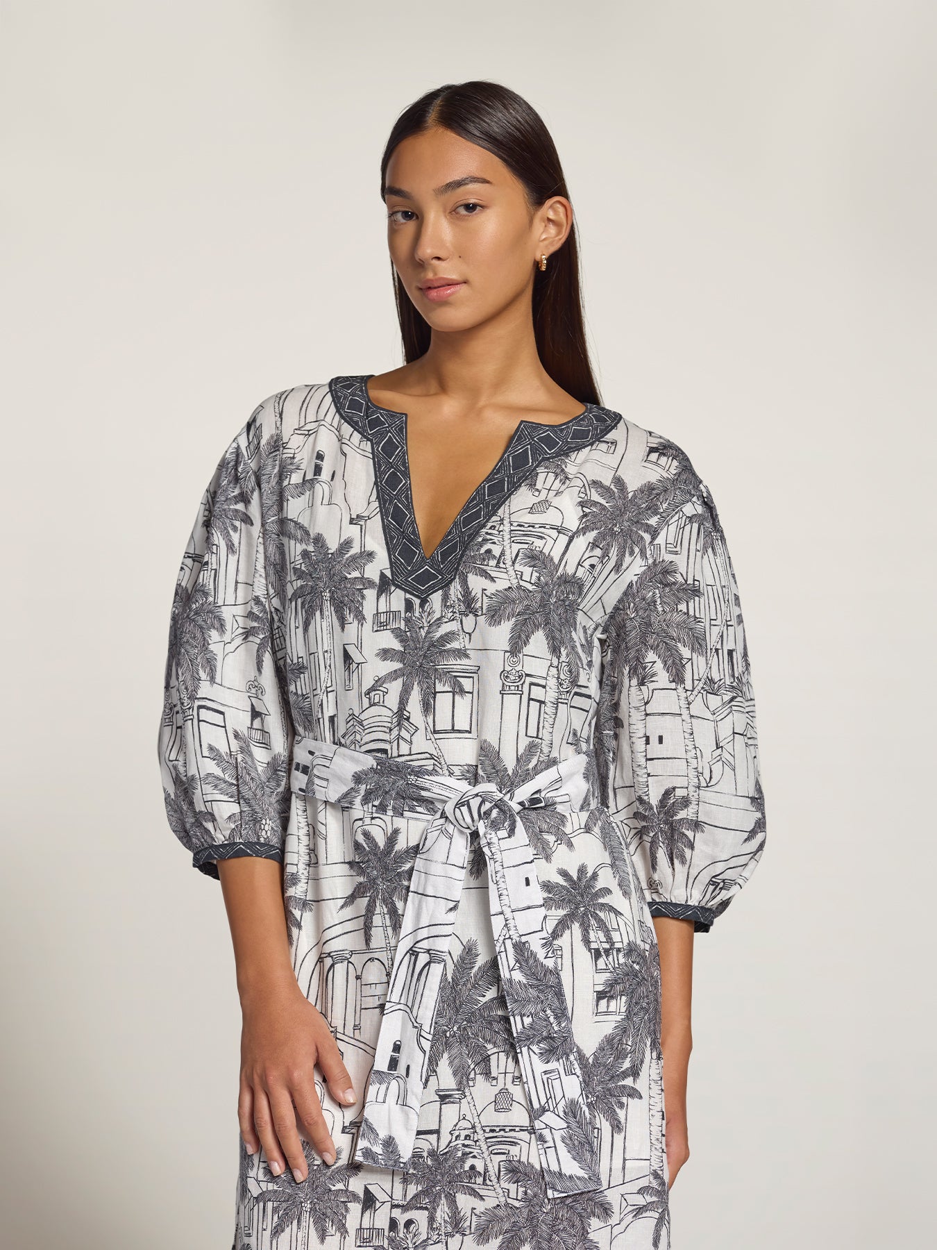 White and grey palm tree-print Landmark Trina linen caftan with tie-waist and V-neckline, front view.