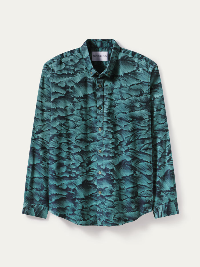 A long-sleeve button-up shirt with a dark teal and black leaf-like pattern, displayed flat against a light off-white background.