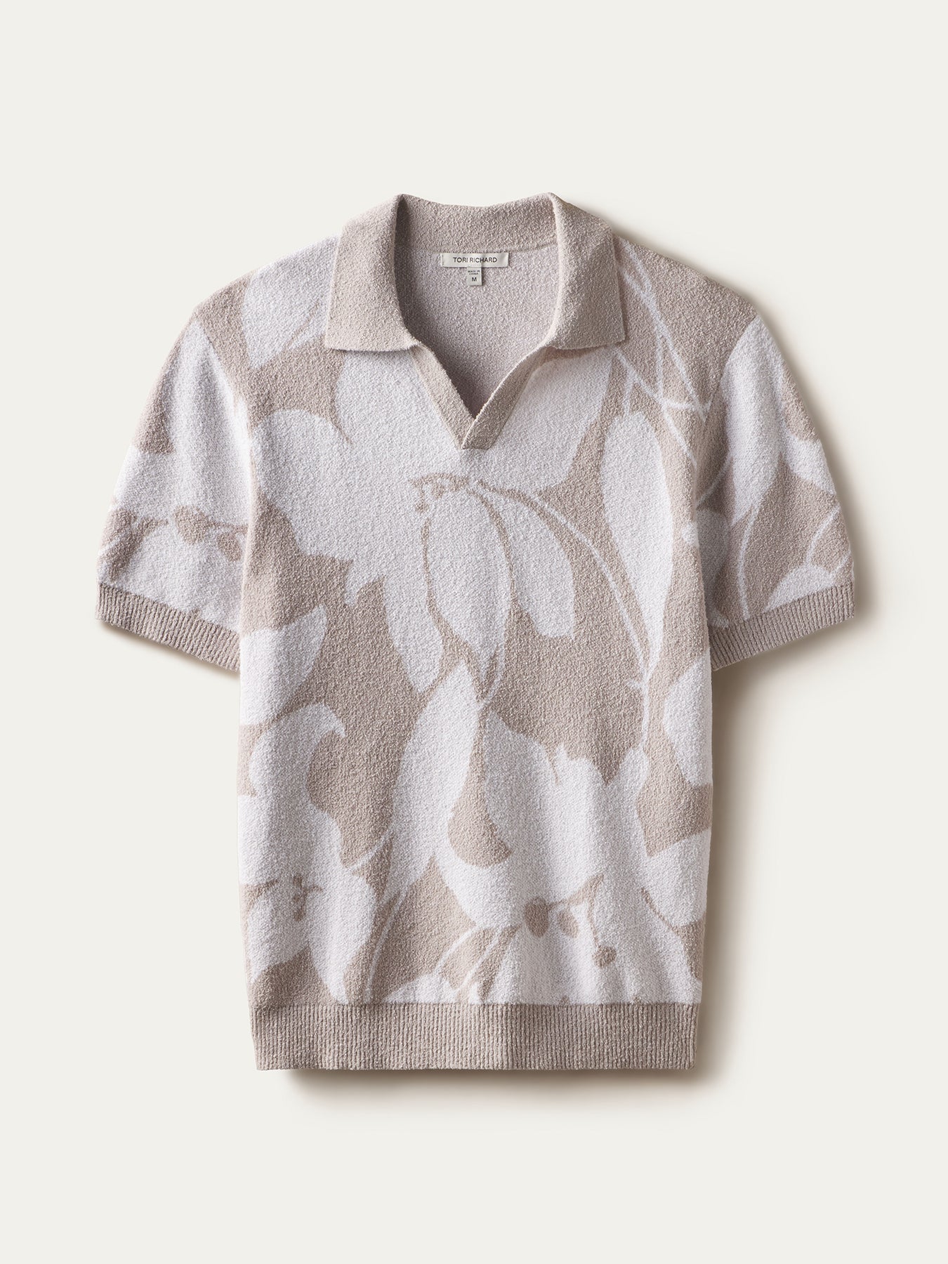 Beige/white floral knit short-sleeve polo with Johnny collar, front view, flat lay view. 