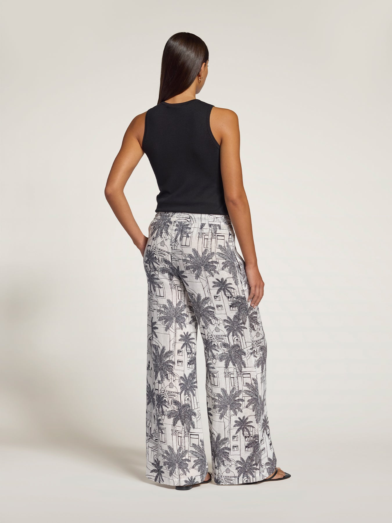 Black sleeveless knit tank and green palm-print pants, back view (shown in Images 1 and 2).
