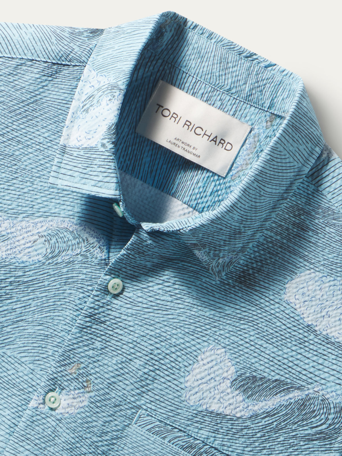 Light blue, cloud-print polyester shirt, short sleeves lightweight polyester with UPF. 