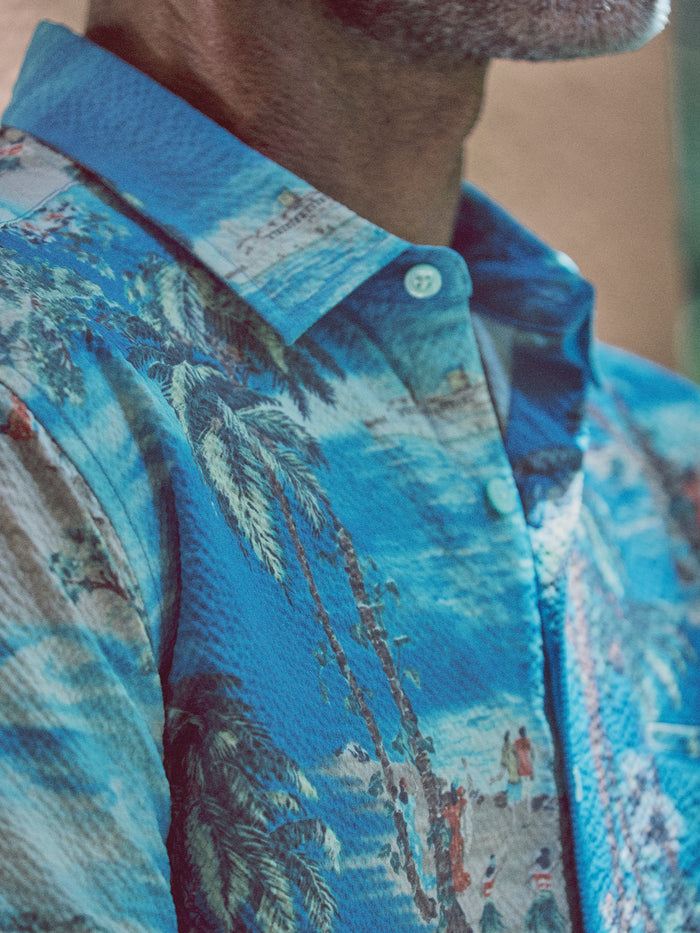Blue tropical-print Bon Voyage Tradewind Technology® collared shirt, close-up view{{/AltText}}.