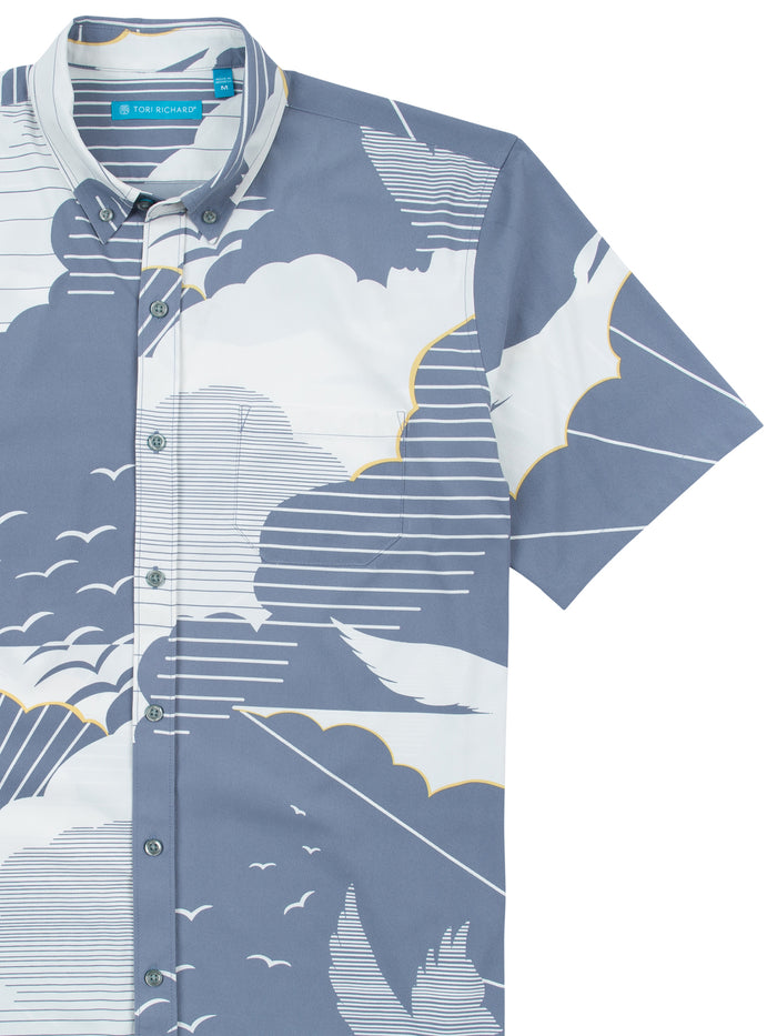 Light blue cloud-and-bird print short-sleeve shirt, front view, moisture-wicking fabric.