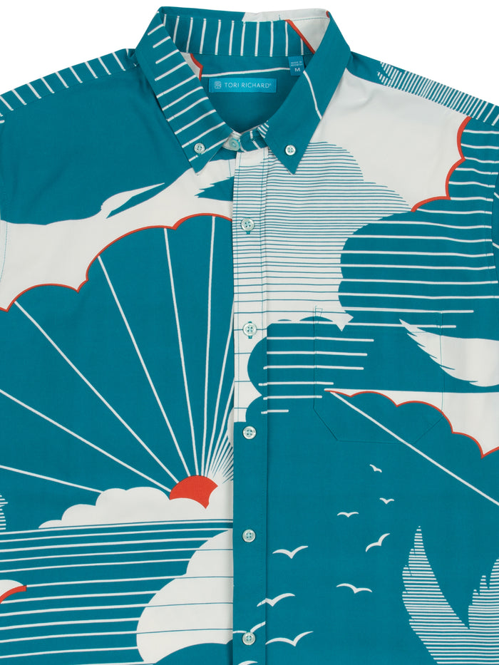 Teal shirt with white and orange graphic, buttoned to collar, moisture-wicking fabric, front view{{/AltText}}.