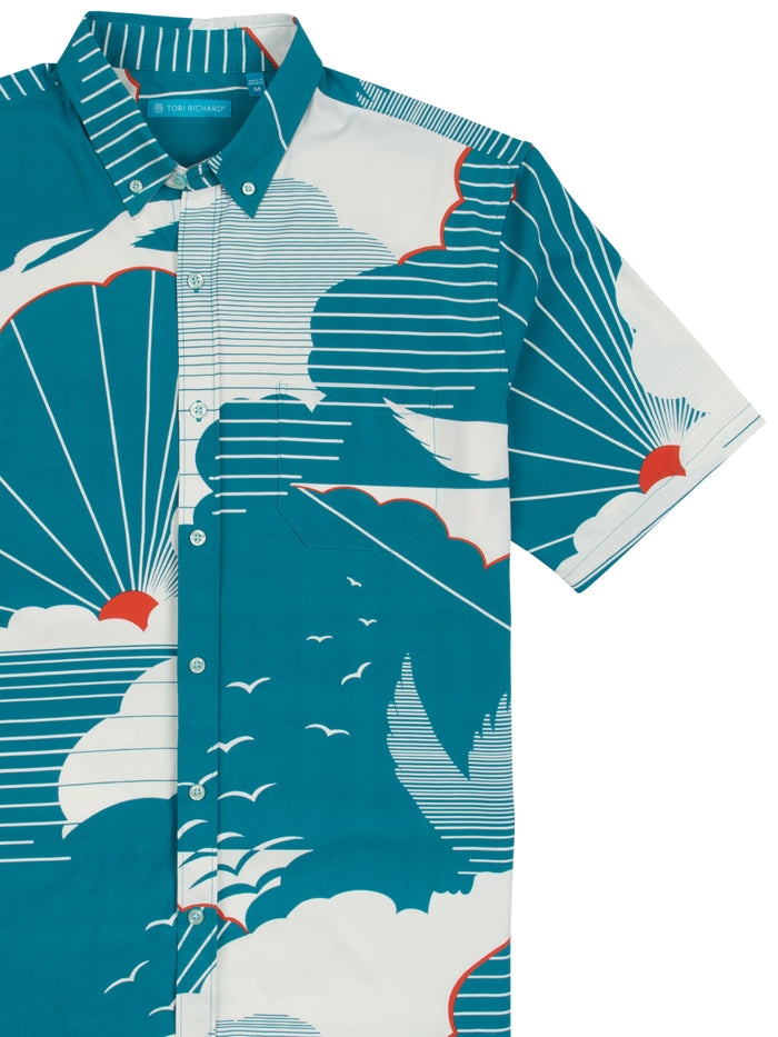 Teal short-sleeve shirt with white and orange cloud-bird print, performance fabric, front view{{/AltText}}.
